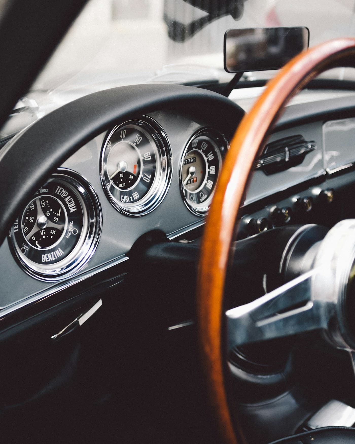 The wood-rimmed wheel and chrome gauges of a classic Alfa Romeo
